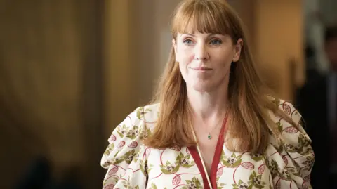 PA Media Deputy Prime Minister Angela Rayner wearing a floral dress and a pendant necklace