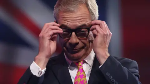 Reuters Nigel Farage wearing glasses at the Reform party conference