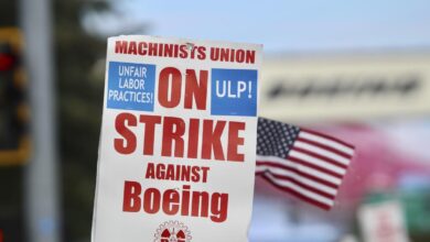 Boeing wing mechanic lead Lee Lara, who has worked for the company for 16 years, yells in response to honks from passing drivers as workers wave picket signs while striking after union members voted to reject a contract offer, Sunday, Sept. 15, 2024, near the company's factory in Everett, Wash. (AP Photo/Lindsey Wasson)