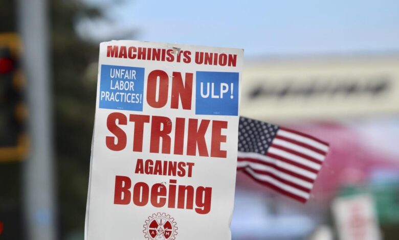 Boeing wing mechanic lead Lee Lara, who has worked for the company for 16 years, yells in response to honks from passing drivers as workers wave picket signs while striking after union members voted to reject a contract offer, Sunday, Sept. 15, 2024, near the company's factory in Everett, Wash. (AP Photo/Lindsey Wasson)