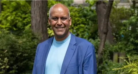 Getty Images A handout picture of Sharar Ali wearing a blazer and t-shirt when he held his role as justice spokesperson for the Green Party.