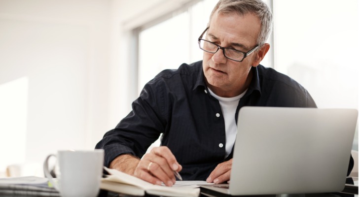 A couple who's approaching retirement meets with their financial advisor to determine if they can retire at 65.