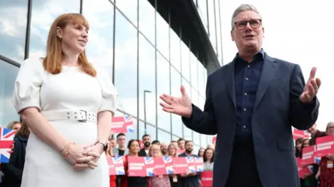 BBC Prime Minister Sir Keir Starmer and Deputy Prime Minister Angela Rayner arrive on the day before the Labour Party Conference in Liverpool