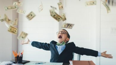 A child celebrates as cash rains down.