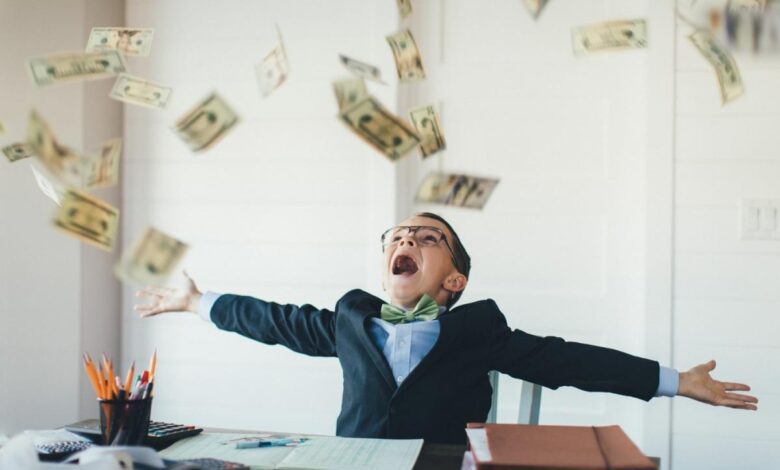 A child celebrates as cash rains down.