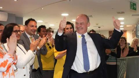 PA Media Liberal Democrat leader Sir Ed Davey is greeted by supporters as he returns to Lib Dems HQ in central London following the result of the 2024 general election