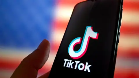 Getty Images TikTok's logo displayed on a smartphone with the US flag in the background