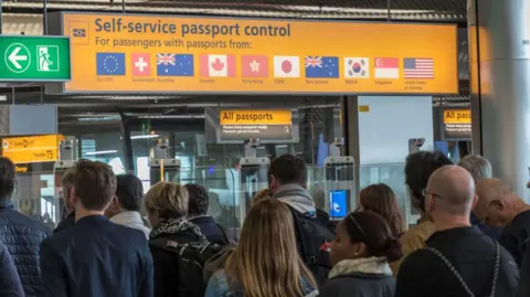 Getty Images Passengers waiting at Amsterdam Airport passport control