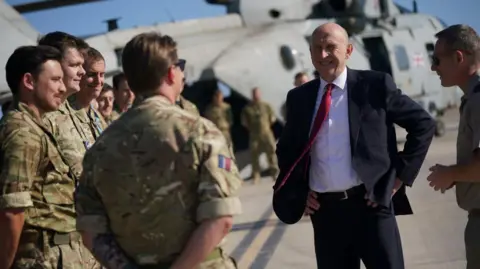 Reuters Defence Secretary John Healey meeting British troops in Cyprus