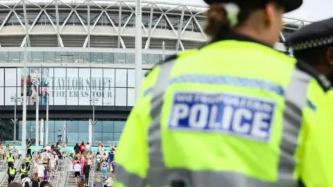 Getty Images A police officer stands outside Wembley Stadium ahead of Taylor Swift's performance on August 15, 2024 in London