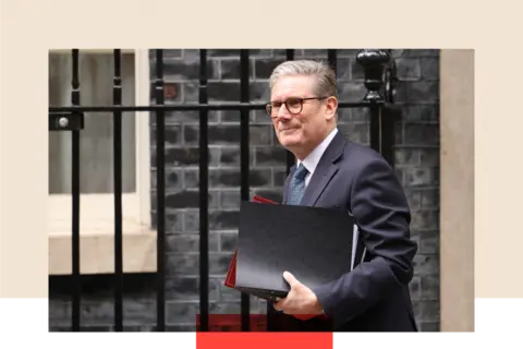 Getty Images Keir Starmer carrying documents as he walks.