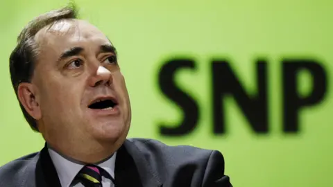 PA Media Alex Salmond speaking in 2007 in front of an SNP logo