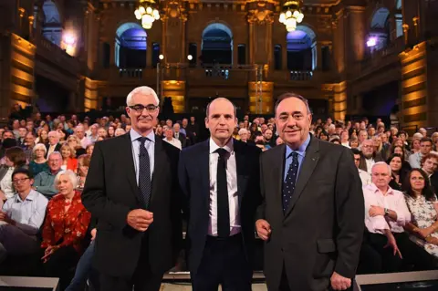 Getty Images Alistair Darling, left, Glenn Campbell, centre, and Alex Salmond stand in front of an audience before a debate ahead of the Scottish independence referendum in 2014 in Kelvingrove Art Gallery, Glasgow.