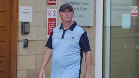 PA Media Raymond Connelly outside court in a blue adidas top and baseball hat