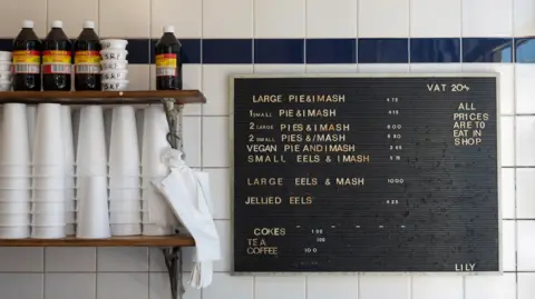 Getty Images Notice board in pie 'n' mash shop with vinegar and polystyrene cups stacked on the left