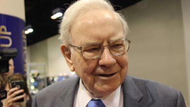 A candid shot of Warren Buffett looking away from the camera.