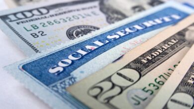 A Social Security card intermixed with U.S. currency.