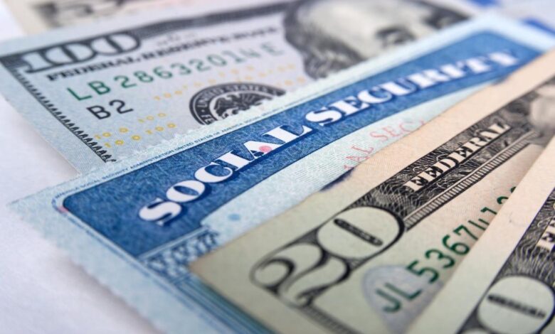 A Social Security card intermixed with U.S. currency.