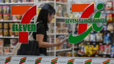 7-Eleven's parent company cuts full-year earnings forecast, presses ahead with restructuring