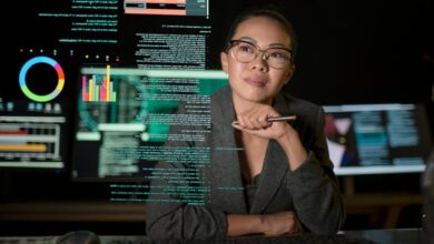 A person studying a see-through display of various charts and graphs.