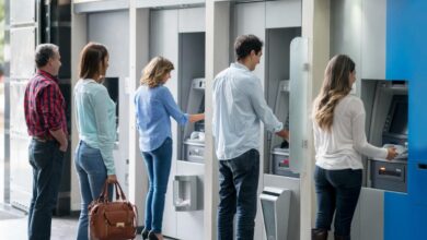 People withdrawing money at an ATM.