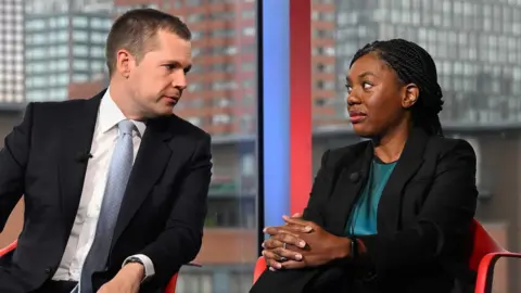 BBC Conservative Party leadership contenders Robert Jenrick and Kemi Badenoch speak to each other while seated on the set of Sunday with Laura Kuenssberg.