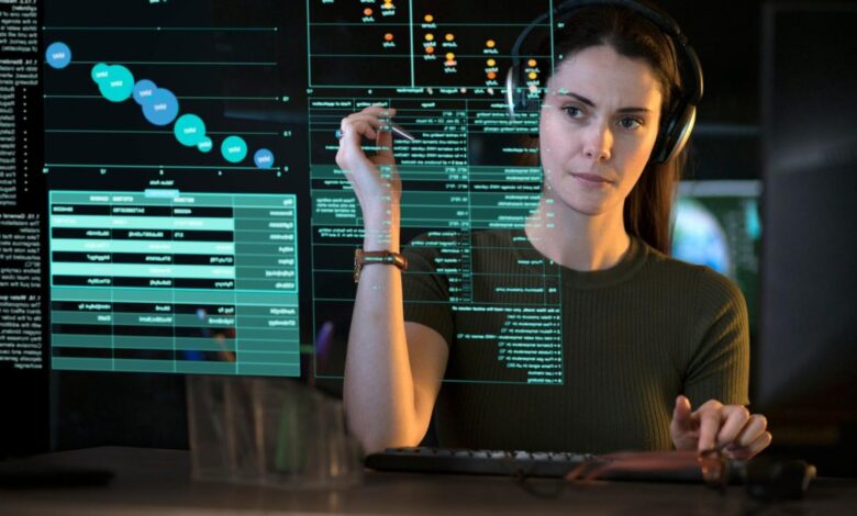 A person looking at graphs and data on a see-though computer display.