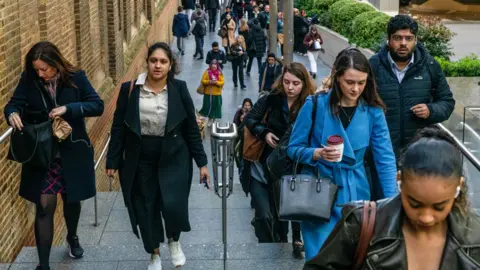 Getty Images Commuters make their way up a set of stone stairs as they walk to work from Liverpool Street train station during the morning rush hour in the City of London, UK, on 16 April 2024. 