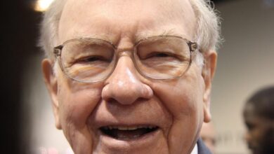 A jubilant Warren Buffett surrounded by people at Berkshire Hathaway's annual shareholder meeting.