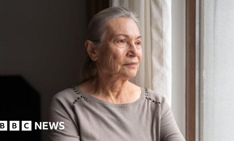 Older woman looking out the window