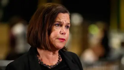 PA Media Mary Lou McDonald is wearing a black blazer and has short brown hair.