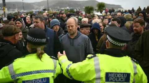 Getty Images A group of protesters facing police in Llandudno