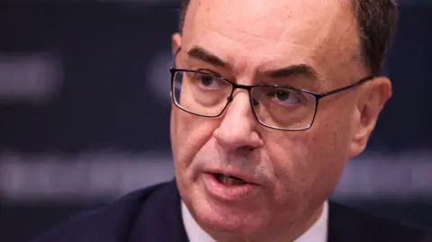 Getty Images Andrew Bailey, Bank of England governor, talking at a press conference after the Bank cut interest rates on 7th November