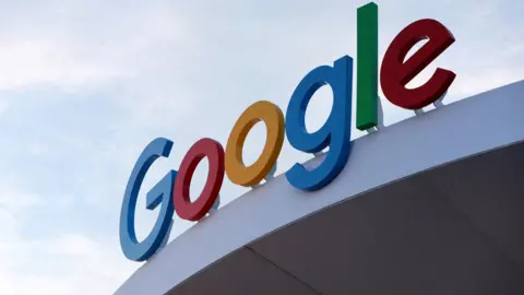 Reuters A close-up of Google's logo displayed on a Google building against the backdrop of a blue sky.