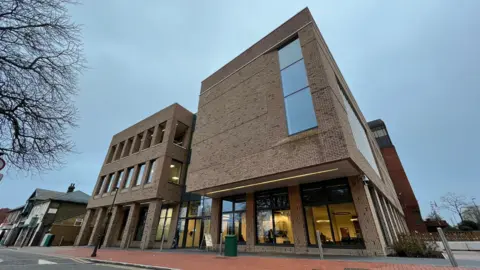 BBC Thurrock Council building - a three-story brick structure with large windows on the ground floor.