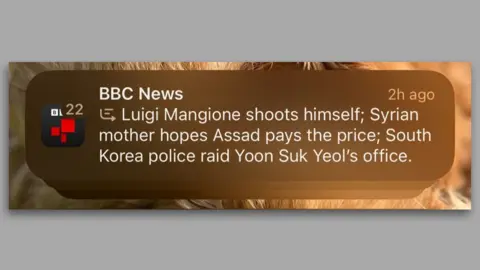 A zoomed in phone screenshot of the misleading BBC notification from an iPhone. It reads: 