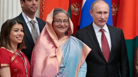 AP President Putin with Tulip Siddiq and Bangladesh PM Sheikh Hasina pose for photos infront of Russian and Bangladeshi flags during the signing of a deal to build the Rooppur Power Plant Project in Bangladesh