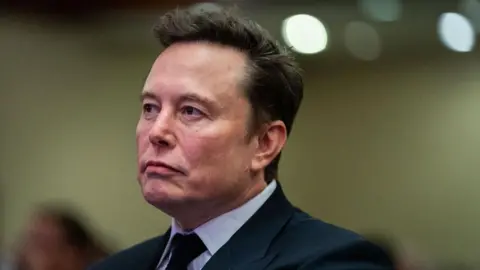 Getty Images Elon Musk listens as US President-elect Donald Trump speaks during a House Republicans Conference meeting at the Hyatt Regency on Capitol Hill on November 13, 2024 in Washington, DC.