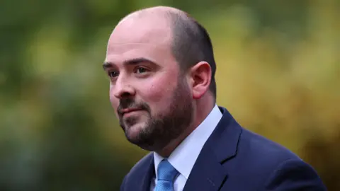 Reuters Conservative MP Richard Holden, wearing a suit and blue tie