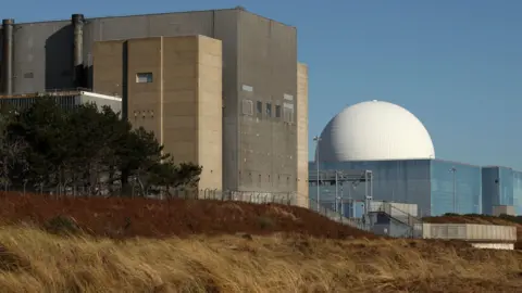 PA Media Sizewell B nuclear power station in Suffolk. There are two large buildings, including one with a large white dome on its roof