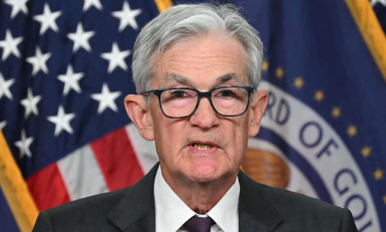 Fed holds rates steady, takes less confident view on inflation