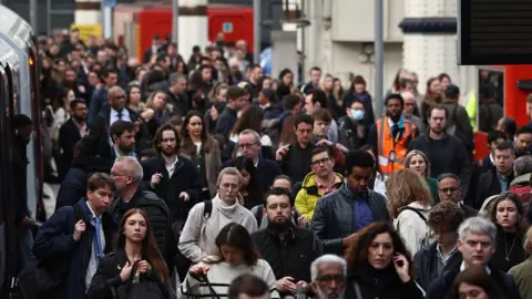 AFP via Getty Images Crowds of people getting off a train at Waterloo station