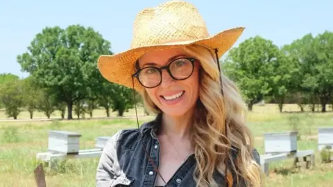 Aimee Aubin Woman wears straw hat 