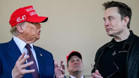 Reuters Elon Musk listens in conversation with U.S. President-elect Donald Trump at a viewing of the launch of the sixth test flight of the SpaceX