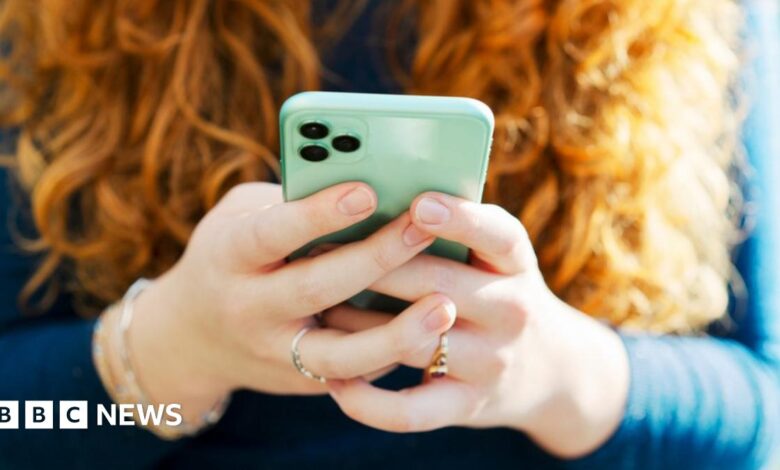 A woman's hands holding a mobile phone