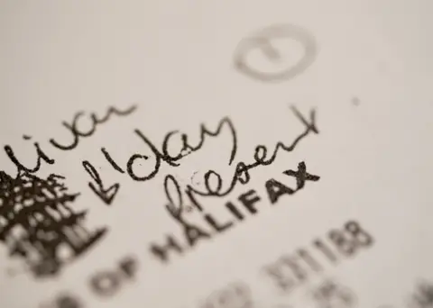 A receipt which has the handwritten note B'day Present on it