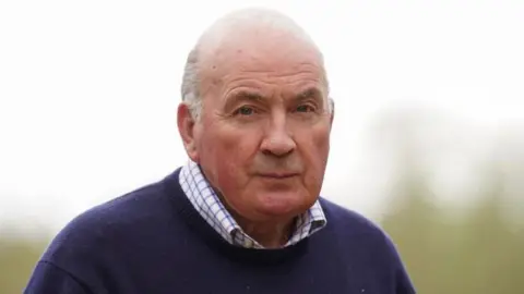 PA Media A headshot of Lord Dannatt, wearing a shirt and navy blue jumper