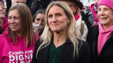 Getty Images Kim Leadbeater standing alongside campaigners wearing pink outside Parliament