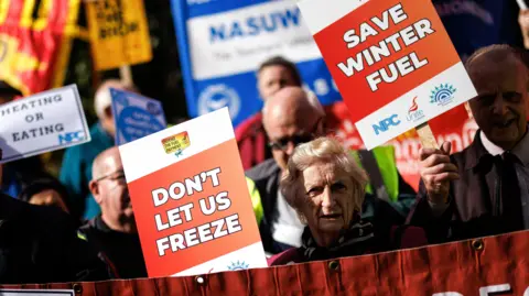 EPA Protesters hold placards and banners while campaigning for the reversal of the winter fuel payment cuts to pensioners, which is proposed by the British government, at Old Palace Yard, in London, Britain, 7 October 2024.