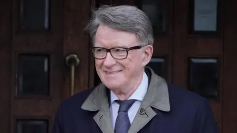 PA Media Peter Mandelson, dressed in a formal shirt, tie and outdoors jacket